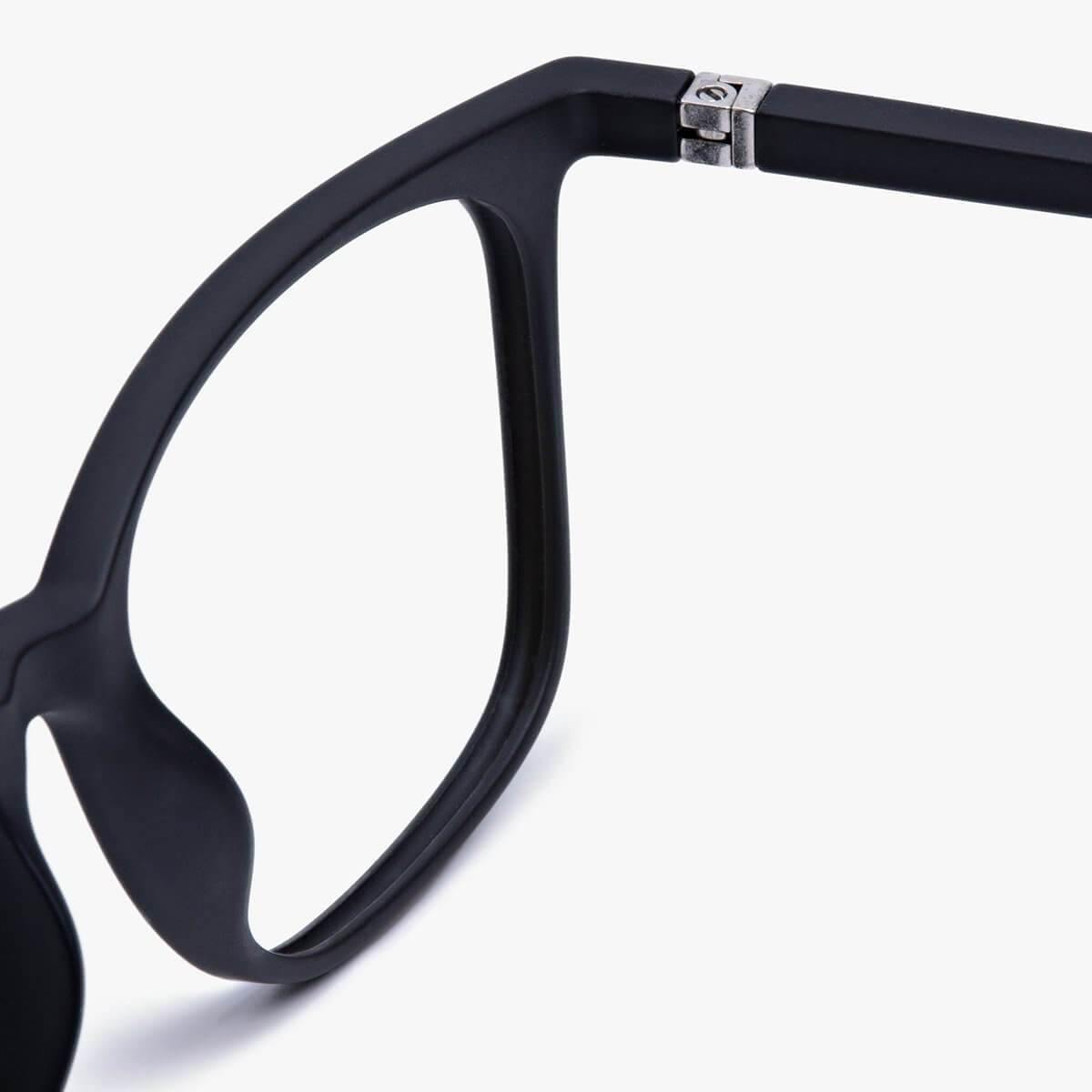 Close-up of Fyn Black eyeglasses with a matte black finish and silver detail