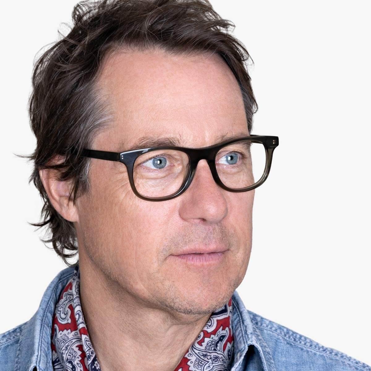 Person wearing Malmö Shiny Olive glasses